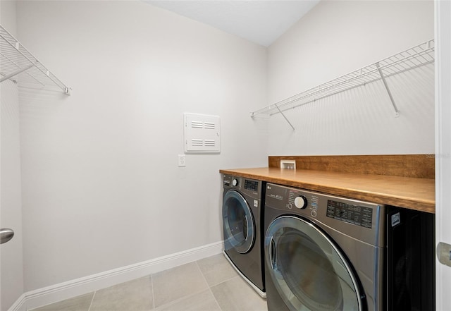 laundry room featuring light tile patterned floors and washing machine and clothes dryer