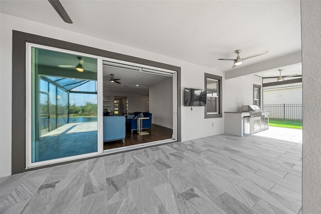 view of patio / terrace featuring ceiling fan and a grill