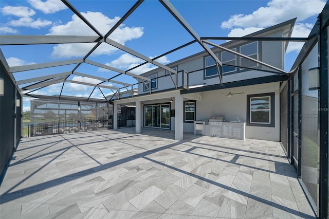 view of patio / terrace with area for grilling, ceiling fan, a balcony, and glass enclosure