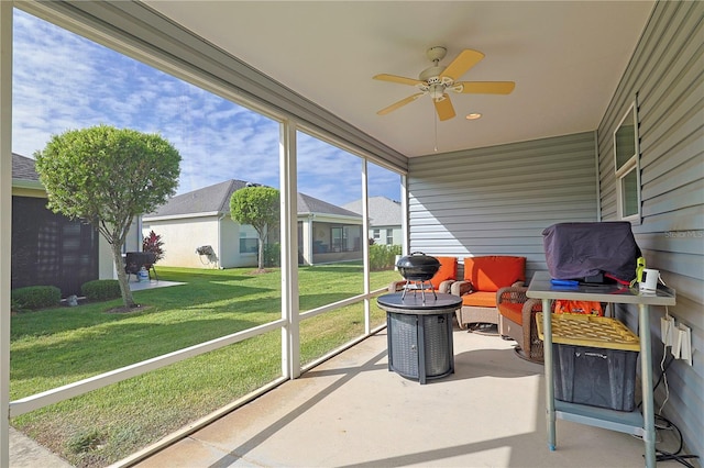 sunroom / solarium featuring ceiling fan