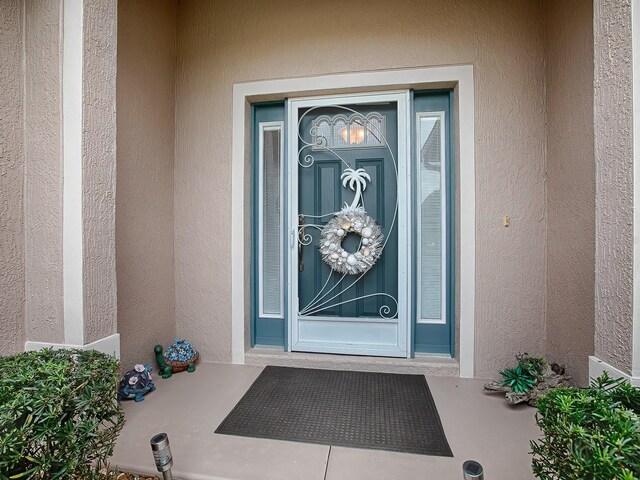 doorway to property with stucco siding