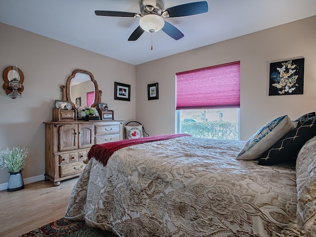 bedroom with ceiling fan and light hardwood / wood-style flooring