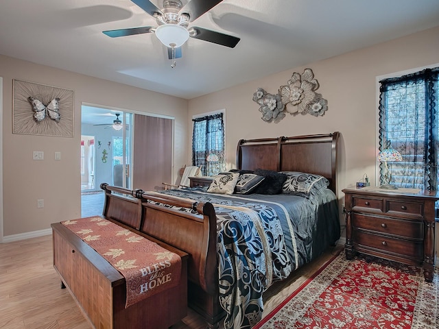 bedroom featuring multiple windows, ceiling fan, and light hardwood / wood-style flooring