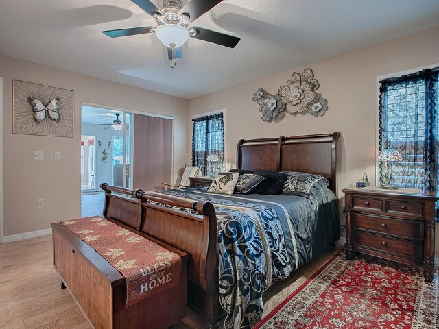 bedroom with baseboards, wood finished floors, and a ceiling fan