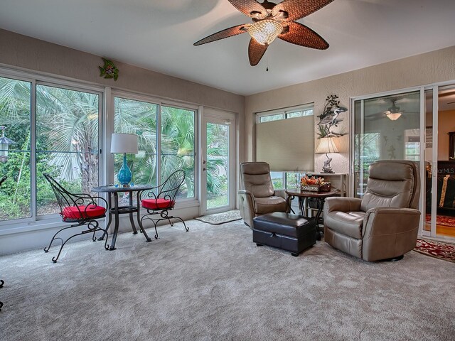 living area with carpet flooring and a ceiling fan