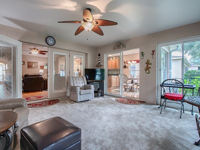 carpeted living area featuring ceiling fan