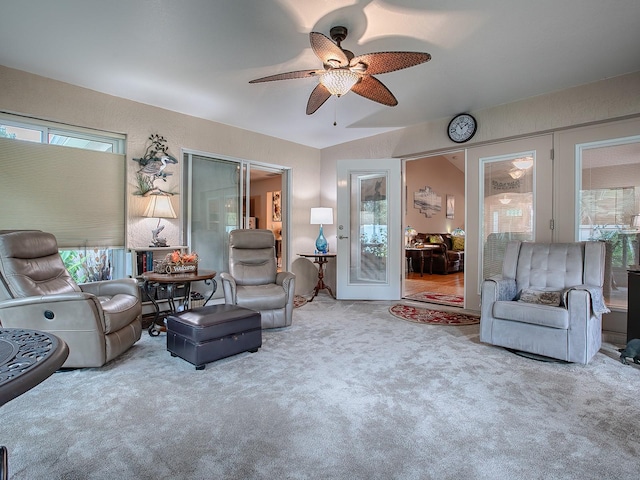 carpeted living room with ceiling fan