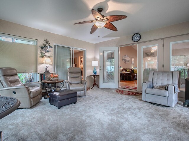 living room featuring carpet and a ceiling fan