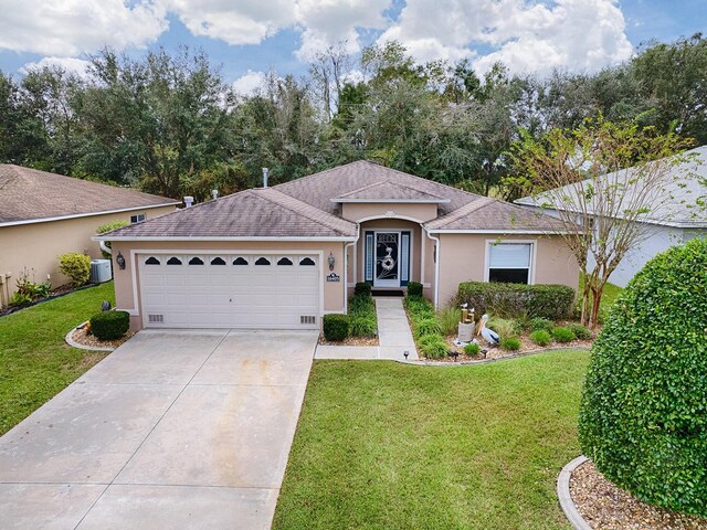 ranch-style home with stucco siding, driveway, a garage, a front yard, and central AC