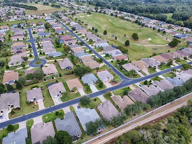 aerial view of property and surrounding area with nearby suburban area and a golf club