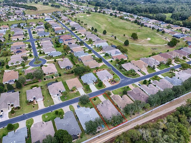 aerial perspective of suburban area with property boundaries highlighted and a golf course