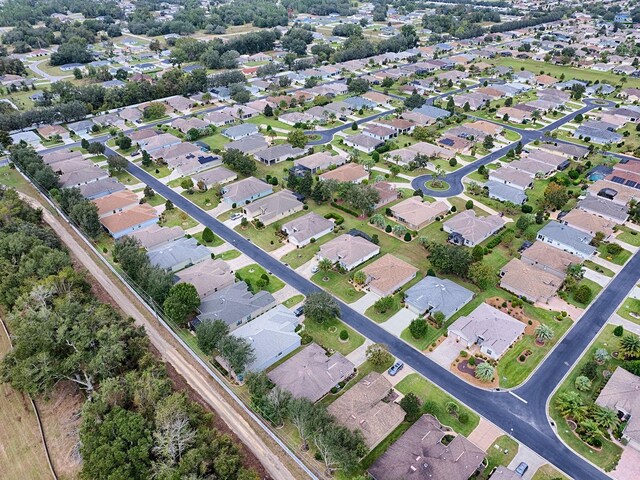aerial view of property and surrounding area featuring nearby suburban area