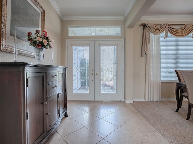 tiled foyer entrance with crown molding and french doors