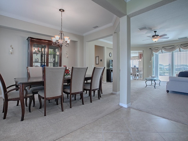 dining space with ornamental molding, ceiling fan with notable chandelier, and light carpet