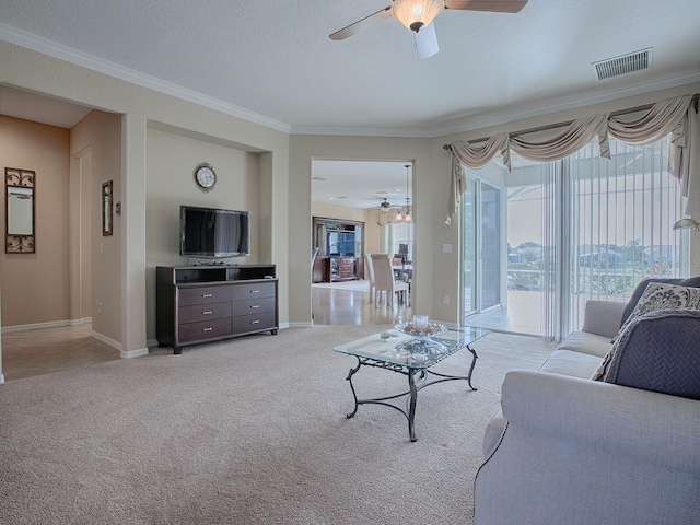 carpeted living room with ceiling fan, a textured ceiling, and ornamental molding