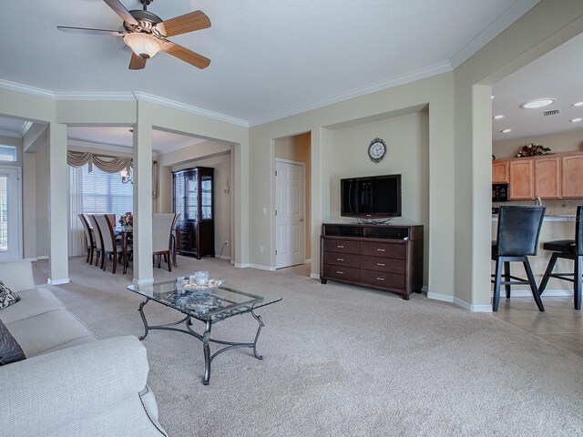 living room featuring light carpet, ceiling fan, and crown molding