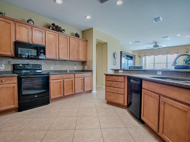 kitchen with black appliances, sink, light tile patterned floors, ceiling fan, and backsplash