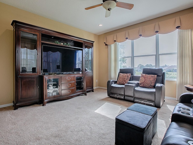 living room featuring ceiling fan and light colored carpet