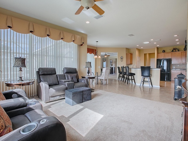 living room with ceiling fan and light tile patterned floors