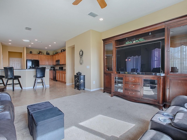 living room with light colored carpet and ceiling fan