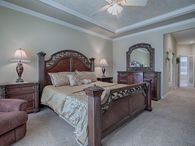 carpeted bedroom with ornamental molding, ensuite bath, a textured ceiling, and ceiling fan