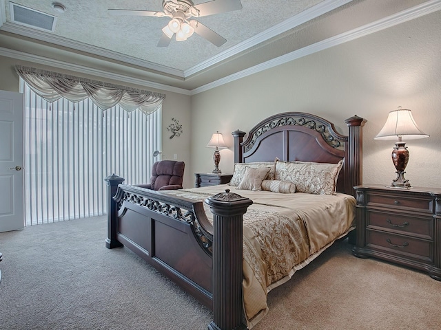 bedroom with crown molding, carpet floors, a textured ceiling, a raised ceiling, and ceiling fan