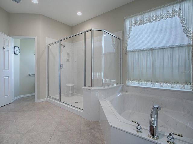 bathroom with separate shower and tub and tile patterned floors