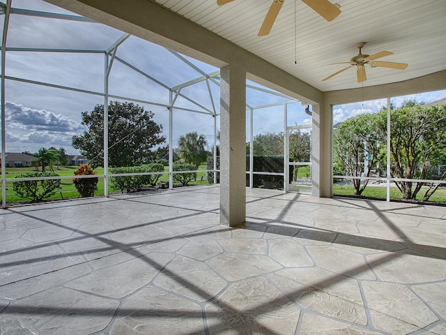 unfurnished sunroom featuring ceiling fan