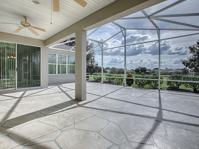 unfurnished sunroom with ceiling fan