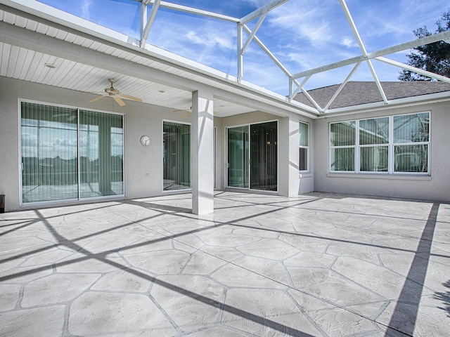 unfurnished sunroom with a wealth of natural light and ceiling fan