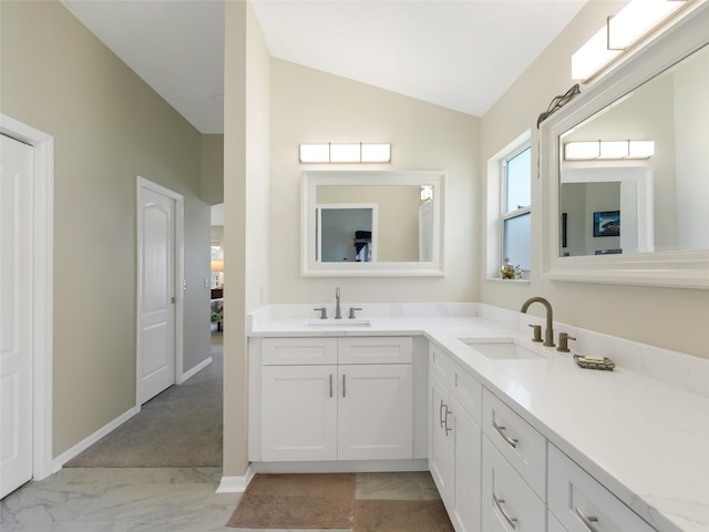 bathroom with lofted ceiling and vanity