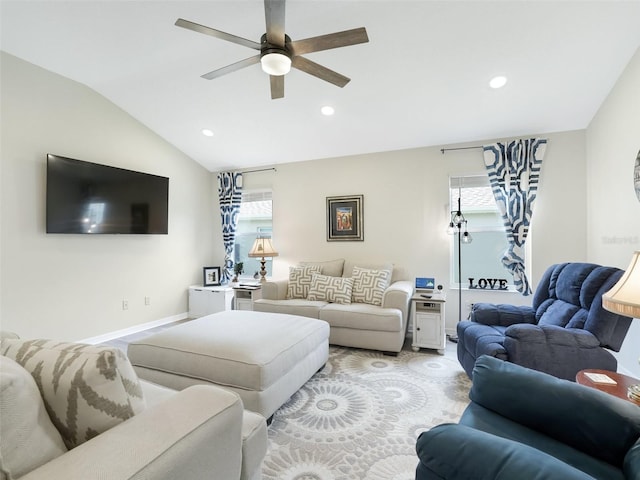 living room featuring ceiling fan, a healthy amount of sunlight, and lofted ceiling