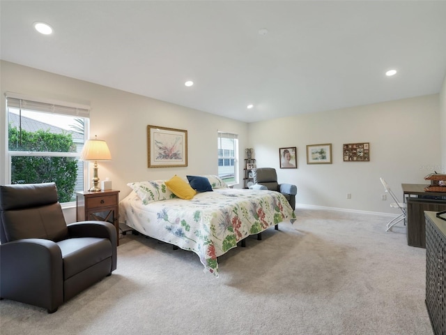 bedroom with multiple windows and light carpet