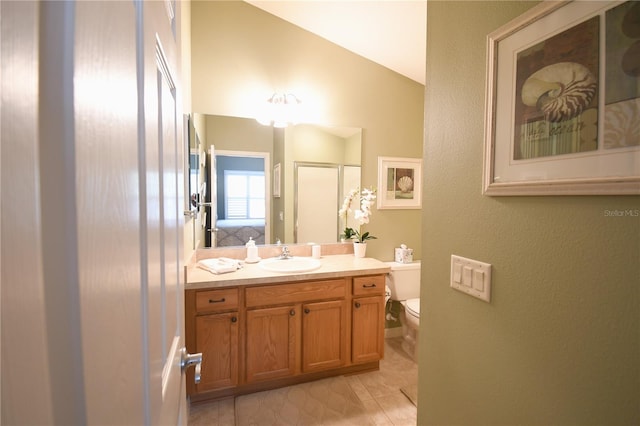 bathroom with vanity, toilet, walk in shower, and vaulted ceiling