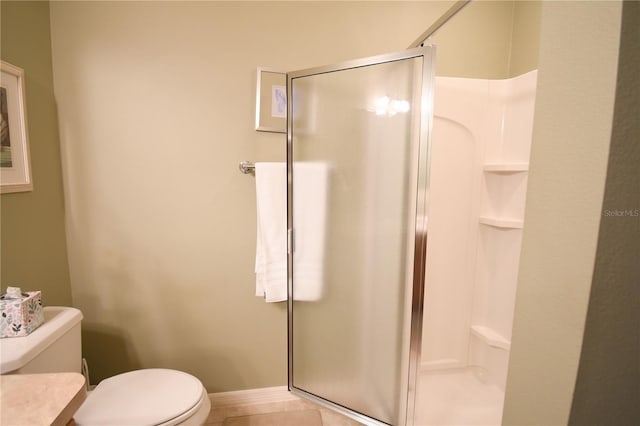 bathroom featuring toilet, tile patterned flooring, and walk in shower