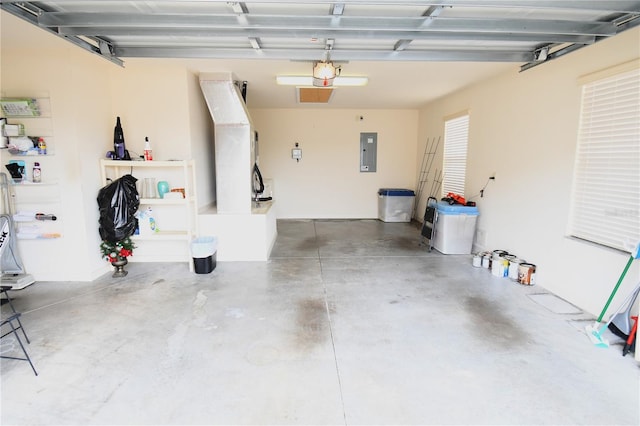 garage featuring electric panel and a garage door opener