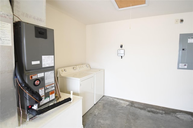 clothes washing area featuring washing machine and dryer, electric panel, and heating unit