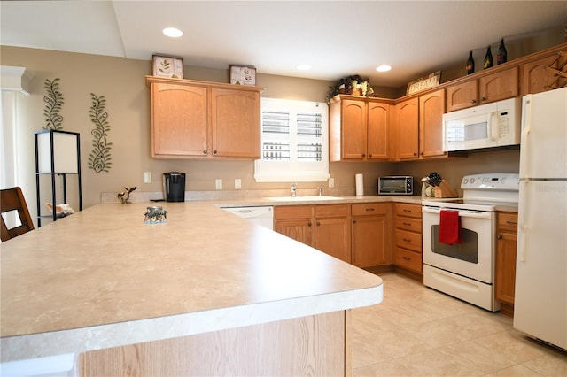 kitchen with sink, white appliances, kitchen peninsula, and light tile patterned floors