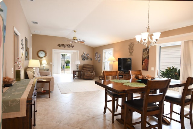 dining space featuring light tile patterned floors, ceiling fan with notable chandelier, and vaulted ceiling