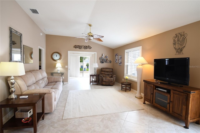 living room with ceiling fan, light tile patterned floors, and vaulted ceiling