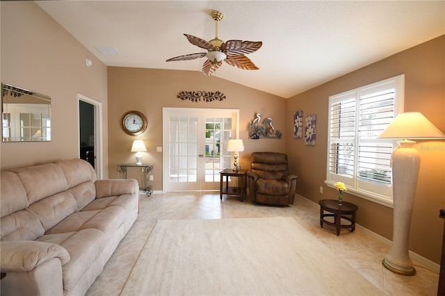 tiled living room with ceiling fan, french doors, and vaulted ceiling