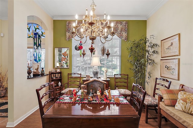 dining area featuring a chandelier, hardwood / wood-style flooring, and crown molding