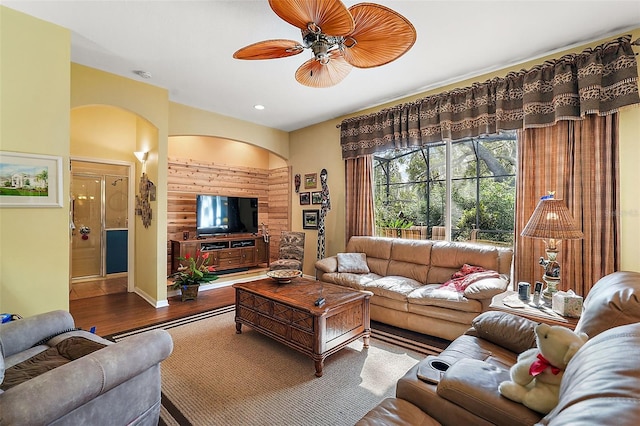 living room featuring ceiling fan and wood-type flooring