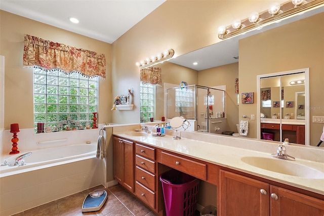 bathroom with independent shower and bath, vanity, and tile patterned flooring