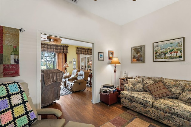 living room featuring ceiling fan and dark hardwood / wood-style floors