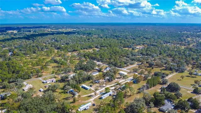 birds eye view of property featuring a view of trees