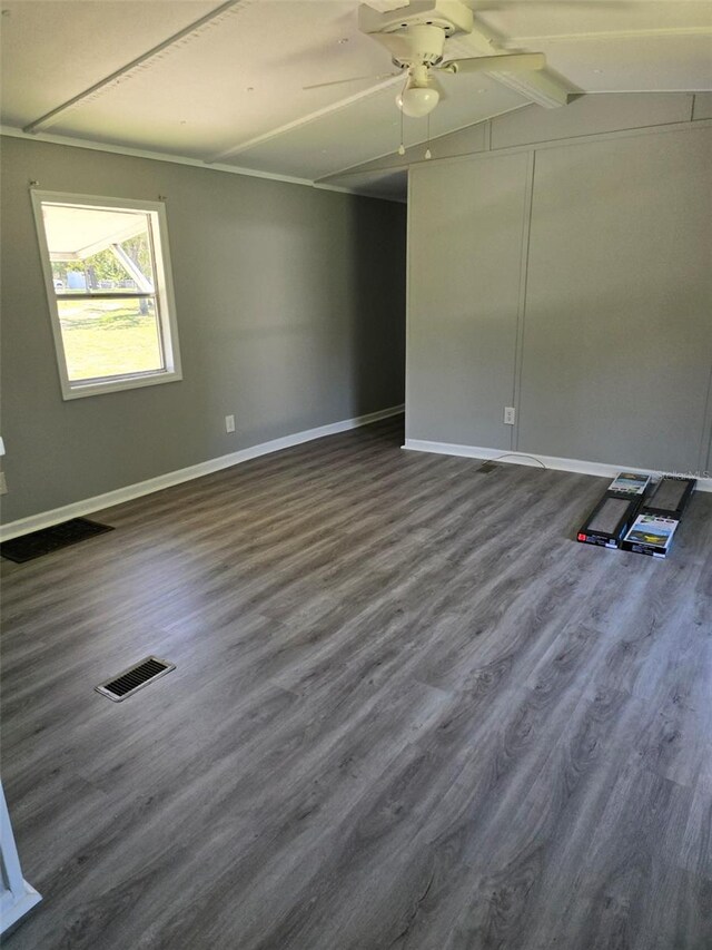 empty room featuring dark wood-style floors, visible vents, ceiling fan, and baseboards