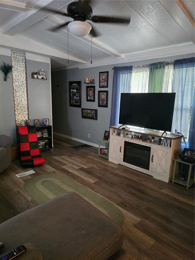 living area featuring baseboards, a ceiling fan, dark wood-type flooring, and ornamental molding