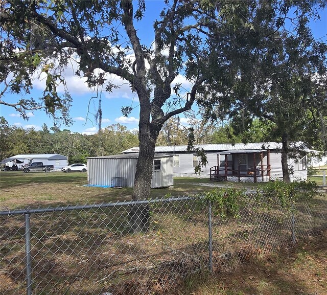 view of yard featuring fence and an outdoor structure