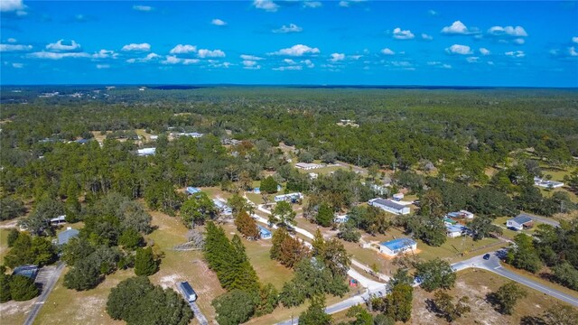 drone / aerial view featuring a forest view